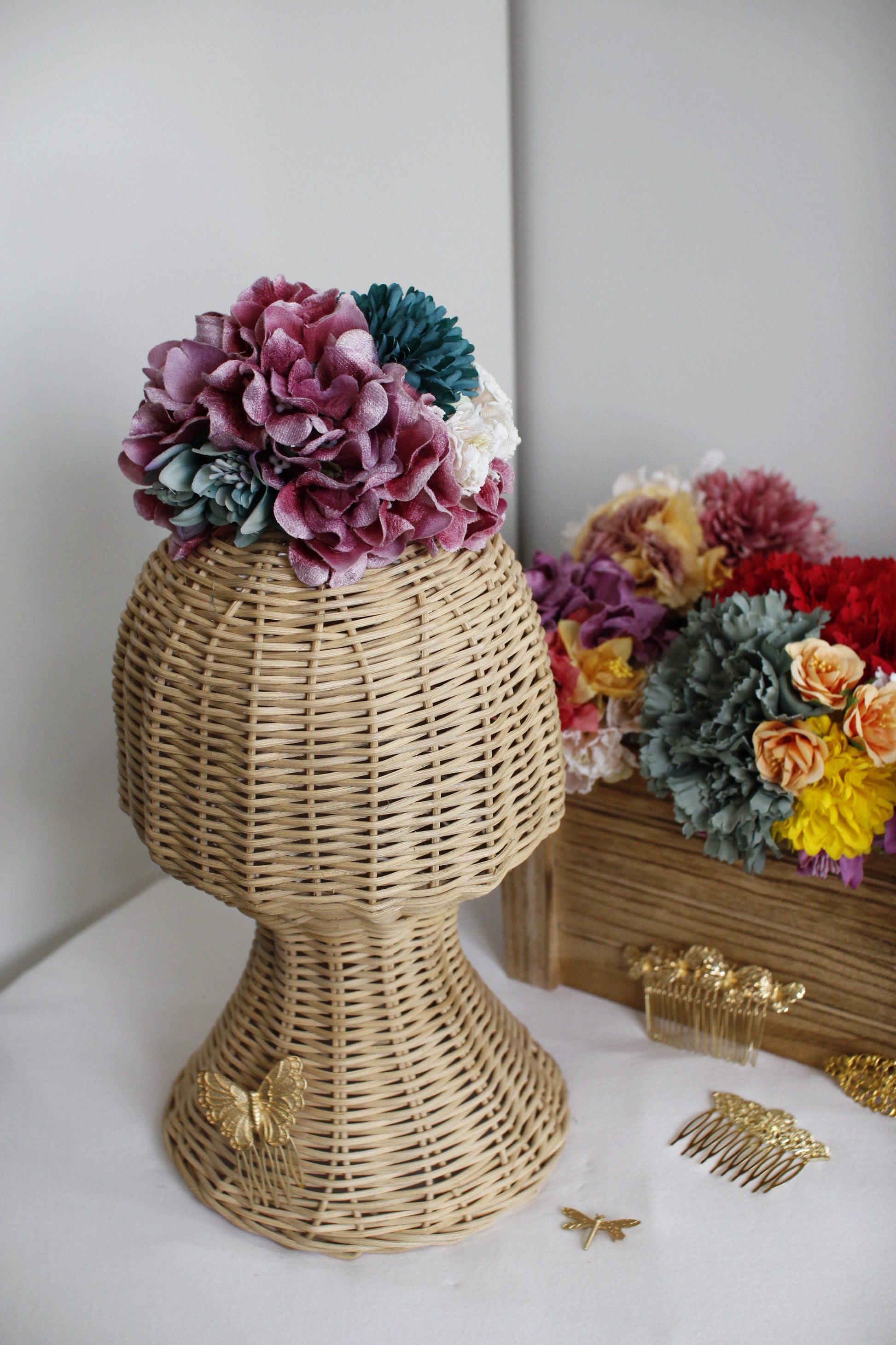 El ramillete de flores Alma en tonos buganvilla y verde agua es un diseño único que destaca por su estilo vibrante y originalidad. Perfecto para complementar tu look flamenco con un toque lleno de magia.