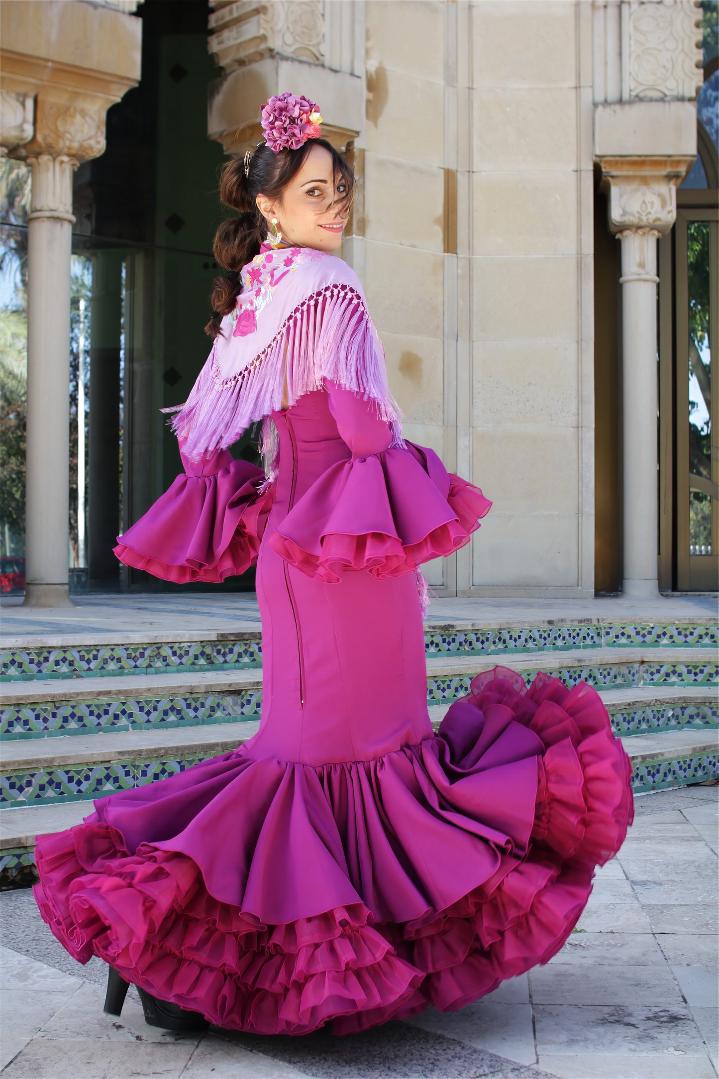 Traje de flamenca buganvilla Clavel con manton lila y con volantes espectaculares y ajuste cómodo, perfecto para lucir con estilo en cualquier evento flamenco.